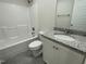 Bathroom with granite vanity, white toilet, and shower-tub combo at 129 Hot Springs Way, Benson, NC 27504