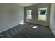 A bright bedroom has two windows overlooking a lush green lawn at 129 Hot Springs Way, Benson, NC 27504