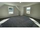 This bonus room features neutral walls and carpet and two large windows at 129 Hot Springs Way, Benson, NC 27504