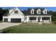 Charming new construction home showcasing a two-car garage, inviting porch, and manicured lawn at 129 Hot Springs Way, Benson, NC 27504