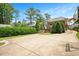 Backyard exterior showing the house, driveway, basketball hoop, and landscaping at 1313 Duplin Rd, Raleigh, NC 27607