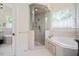 Well-appointed bathroom with a glass shower, soaking tub, and bright natural light at 1313 Duplin Rd, Raleigh, NC 27607