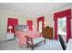 Bedroom with red curtains, white walls and carpet, a bench seat, and traditional furniture at 1313 Duplin Rd, Raleigh, NC 27607