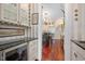 Butler's pantry featuring granite countertops, custom cabinets, and wine cooler at 1313 Duplin Rd, Raleigh, NC 27607