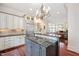 Open-concept kitchen with gas cooktop, granite counters, and ample cabinet space at 1313 Duplin Rd, Raleigh, NC 27607