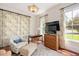 Cozy living area with natural light, floral accents, and hardwood flooring at 1313 Duplin Rd, Raleigh, NC 27607