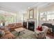 Bright and airy living room with a fireplace, large windows, and elegant furnishings at 1313 Duplin Rd, Raleigh, NC 27607