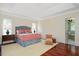 Serene main bedroom with a decorative tray ceiling, stylish furniture, and an en-suite bathroom at 1313 Duplin Rd, Raleigh, NC 27607