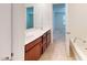 Bathroom featuring a double sink vanity, tub, tiled floors, neutral walls, and white doors and trim at 1365 Scholar Dr, Durham, NC 27703
