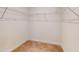 Walk-in closet with neutral walls and neutral carpet features built in wire shelving at 1365 Scholar Dr, Durham, NC 27703