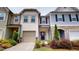 Charming townhouse with beige siding, front garden, and attached one-car garage with concrete driveway at 1365 Scholar Dr, Durham, NC 27703