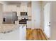 Well-lit kitchen with granite countertops, stainless steel appliances, and white cabinets, flowing into dining at 1365 Scholar Dr, Durham, NC 27703