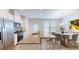 Modern kitchen with granite countertops, stainless steel appliances, and a breakfast bar leading to the dining area at 1365 Scholar Dr, Durham, NC 27703