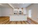 Modern kitchen with granite countertops, stainless steel appliances, and white cabinets, filled with natural light at 1365 Scholar Dr, Durham, NC 27703