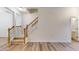 Bright entryway featuring a staircase with wooden railings and a hallway leading to a half bath at 1365 Scholar Dr, Durham, NC 27703