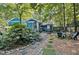Spacious backyard featuring a patio, a sunroom, an outdoor dining area, and lush greenery, perfect for outdoor enjoyment at 1426 Kildaire Farm Rd, Cary, NC 27511