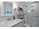 Stylish bathroom featuring a glass-enclosed shower, white vanity, and decorative fixtures at 1426 Kildaire Farm Rd, Cary, NC 27511