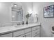 Bright bathroom featuring white marble counters and an elegant decorative mirror at 1426 Kildaire Farm Rd, Cary, NC 27511