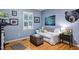 Comfortable bedroom setup with hardwood floors, a white sofa, and lots of natural light at 1426 Kildaire Farm Rd, Cary, NC 27511