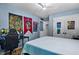 Bedroom for children featuring blue walls, hardwood flooring, ceiling fan, and ample natural light at 1426 Kildaire Farm Rd, Cary, NC 27511