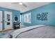 Bright bedroom with blue walls, white trim, ceiling fan, and light-colored wood flooring at 1426 Kildaire Farm Rd, Cary, NC 27511