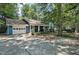 Spacious home with attached garage and a long drive way, surrounded by mature trees at 1426 Kildaire Farm Rd, Cary, NC 27511
