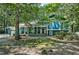 Two-story house showcasing a beautiful lawn with lots of trees on a sunny day at 1426 Kildaire Farm Rd, Cary, NC 27511