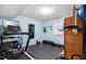 Home gym featuring a treadmill and other exercise equipment on a black padded floor at 1426 Kildaire Farm Rd, Cary, NC 27511