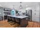 Bright kitchen featuring a large island with seating, stainless steel appliances, and modern pendant lighting at 1426 Kildaire Farm Rd, Cary, NC 27511