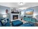 Comfortable living room with a white brick fireplace and entertainment center at 1426 Kildaire Farm Rd, Cary, NC 27511