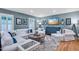 Comfortable living room with a white couch, stylish rug, and serene blue walls at 1426 Kildaire Farm Rd, Cary, NC 27511