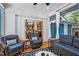 Comfortable sunroom featuring wicker furniture and ample natural light, with access to the exterior of the house at 1426 Kildaire Farm Rd, Cary, NC 27511