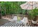 Back deck with a seating area surrounded by lush trees at 1701 Berwickshire Cir, Raleigh, NC 27615