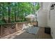 Back deck in a wooded setting, with a seating area and an umbrella at 1701 Berwickshire Cir, Raleigh, NC 27615