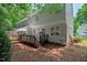 House backyard featuring a deck, lush trees and exterior of home at 1701 Berwickshire Cir, Raleigh, NC 27615