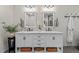 Bathroom featuring a white vanity with double sinks, marble countertop and stylish fixtures at 1701 Berwickshire Cir, Raleigh, NC 27615