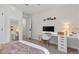 Light and airy bedroom featuring a built-in desk area and mirror, perfect for a home office at 1701 Berwickshire Cir, Raleigh, NC 27615