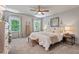 Bright bedroom featuring neutral walls, a ceiling fan, and well-lit windows providing ample natural light at 1701 Berwickshire Cir, Raleigh, NC 27615