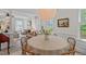 Elegant dining room featuring a round table, woven chairs, and seamless flow to living area at 1701 Berwickshire Cir, Raleigh, NC 27615