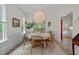 Cozy dining area features a round table, rattan chairs, and natural light streaming through the windows at 1701 Berwickshire Cir, Raleigh, NC 27615