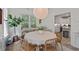 Inviting dining space with natural light, woven chairs, and a view into the kitchen at 1701 Berwickshire Cir, Raleigh, NC 27615