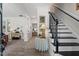 Bright foyer boasts black and white staircase, complemented by stylish decor and open layout at 1701 Berwickshire Cir, Raleigh, NC 27615