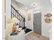 Inviting foyer features a gray front door, elegant staircase with stylish decor and natural light at 1701 Berwickshire Cir, Raleigh, NC 27615