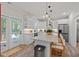 Bright kitchen with a large island, white cabinetry, stainless steel appliances and a door to the outside deck at 1701 Berwickshire Cir, Raleigh, NC 27615