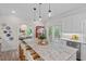 Kitchen island featuring granite countertops, pendant lighting and four chairs, as well as stainless steel appliances at 1701 Berwickshire Cir, Raleigh, NC 27615