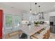 Bright kitchen with a large island, white cabinetry, stainless steel appliances and a door to the outside deck at 1701 Berwickshire Cir, Raleigh, NC 27615