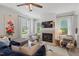 Bright living room showcasing a fireplace, stylish decor, and large windows with elegant curtains at 1701 Berwickshire Cir, Raleigh, NC 27615