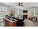 Cozy living room features a fireplace, large windows with curtains, and stylish decor elements at 1701 Berwickshire Cir, Raleigh, NC 27615