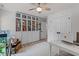 Office with a large bookcase, white desk, neutral rug, and two doors at 1701 Berwickshire Cir, Raleigh, NC 27615
