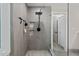 Contemporary bathroom with a glass-enclosed shower featuring gray tiling and modern fixtures at 1701 Berwickshire Cir, Raleigh, NC 27615